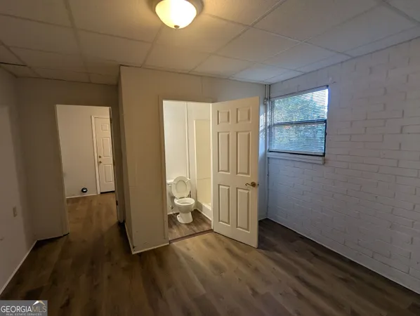 a view of a room with wooden floor and cabinet