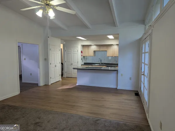 a kitchen with stainless steel appliances granite countertop a sink and a refrigerator