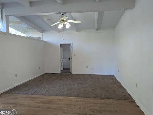 an empty room with wooden floor