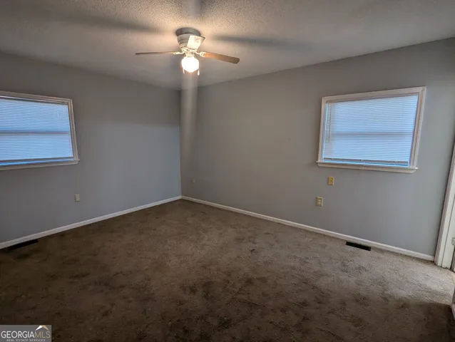 a view of an empty room with a fan