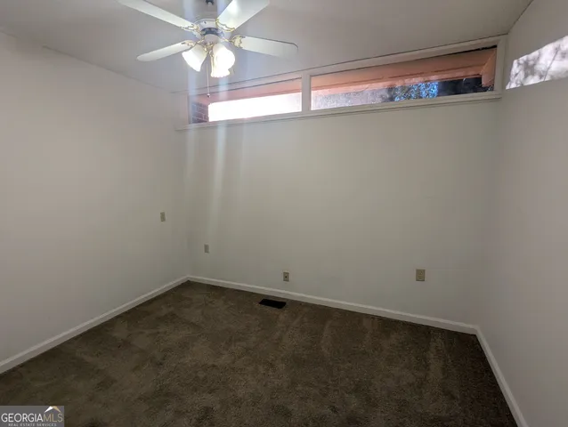 a view of a room with window and a fan