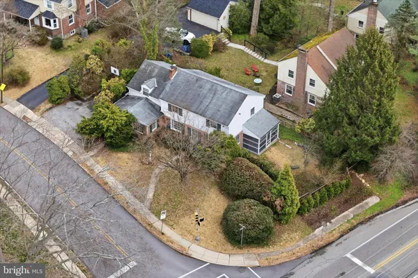 an aerial view of a house with a yard and lake view
