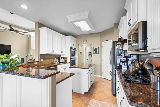 a kitchen that has a lot of cabinets a sink and a stove in it