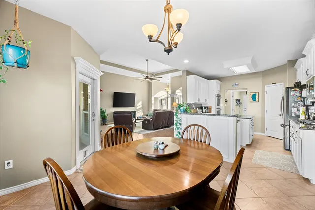 a dining room with furniture and a chandelier