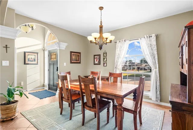 a view of a dining room with furniture and a chandelier