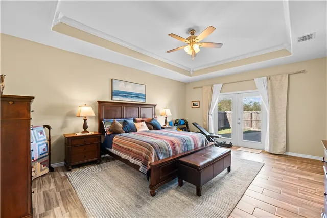 a bedroom with a large bed and a chandelier