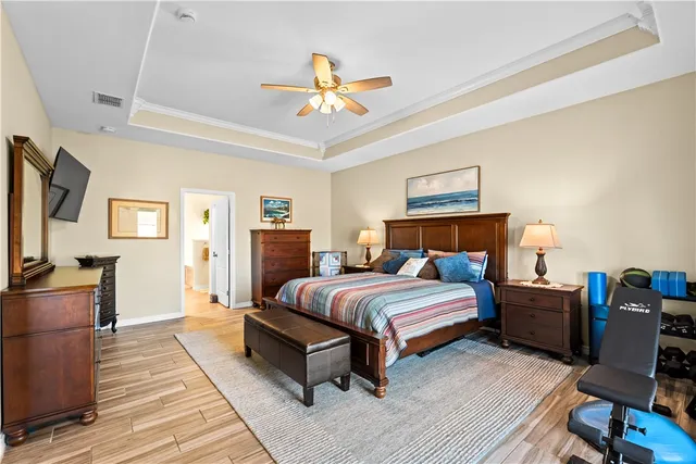 a bedroom with bed and wooden floor