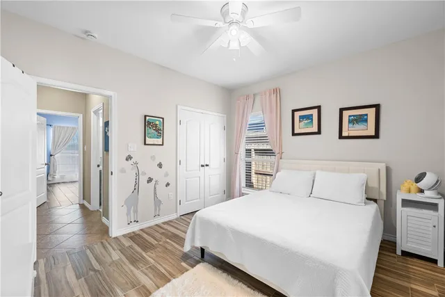 a bedroom with a large bed and a chandelier