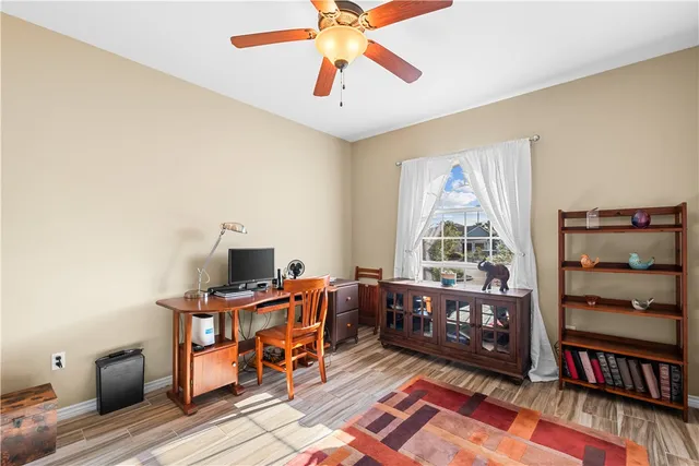 a view of a workspace with furniture and a window