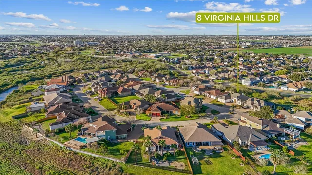 an aerial view of residential houses with outdoor space and parking