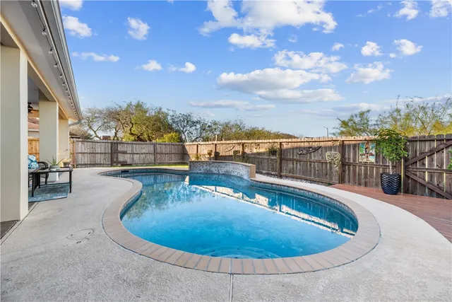 a view of a swimming pool with a lounge chairs