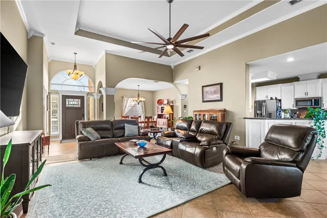a living room with furniture a fireplace and a flat screen tv
