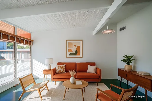 a living room with furniture and a potted plant