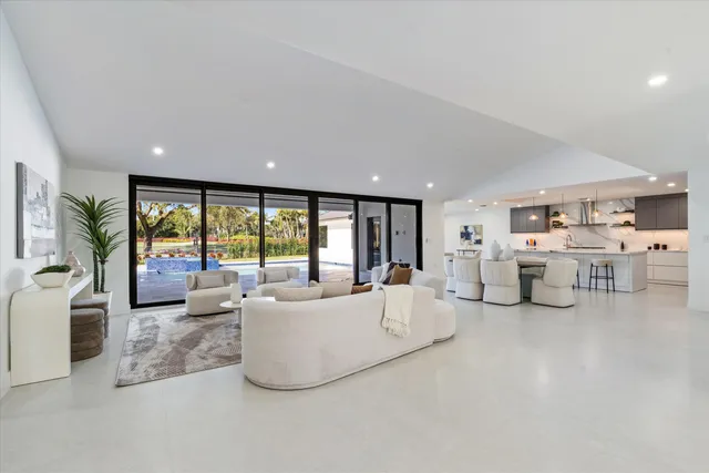 a spacious bedroom with a bed and glass window