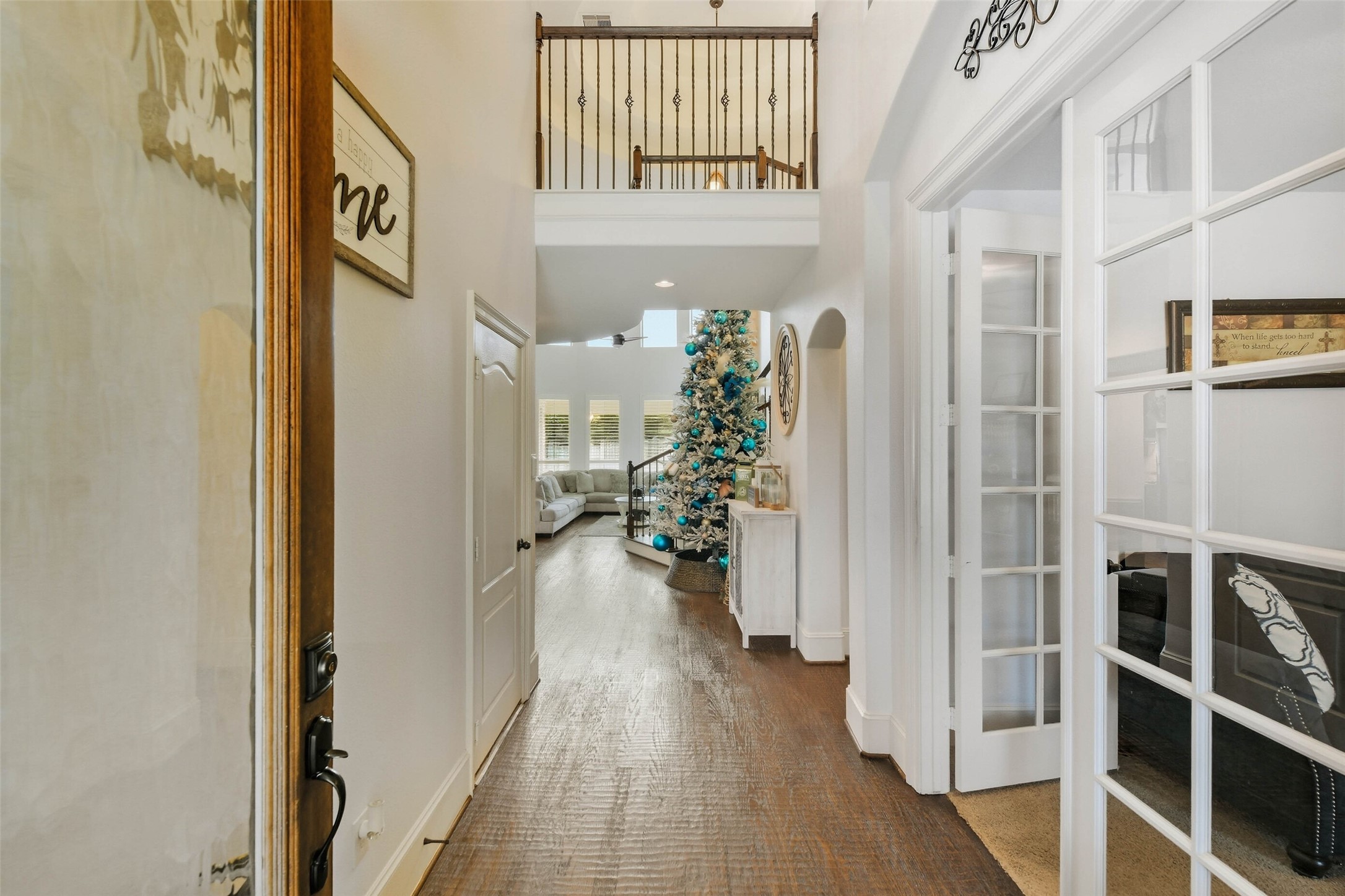 17611 Fossil Ridge Lane Humble, TX 77346 - Photo 3 of 36 a view of a hallway with wooden floor and windows