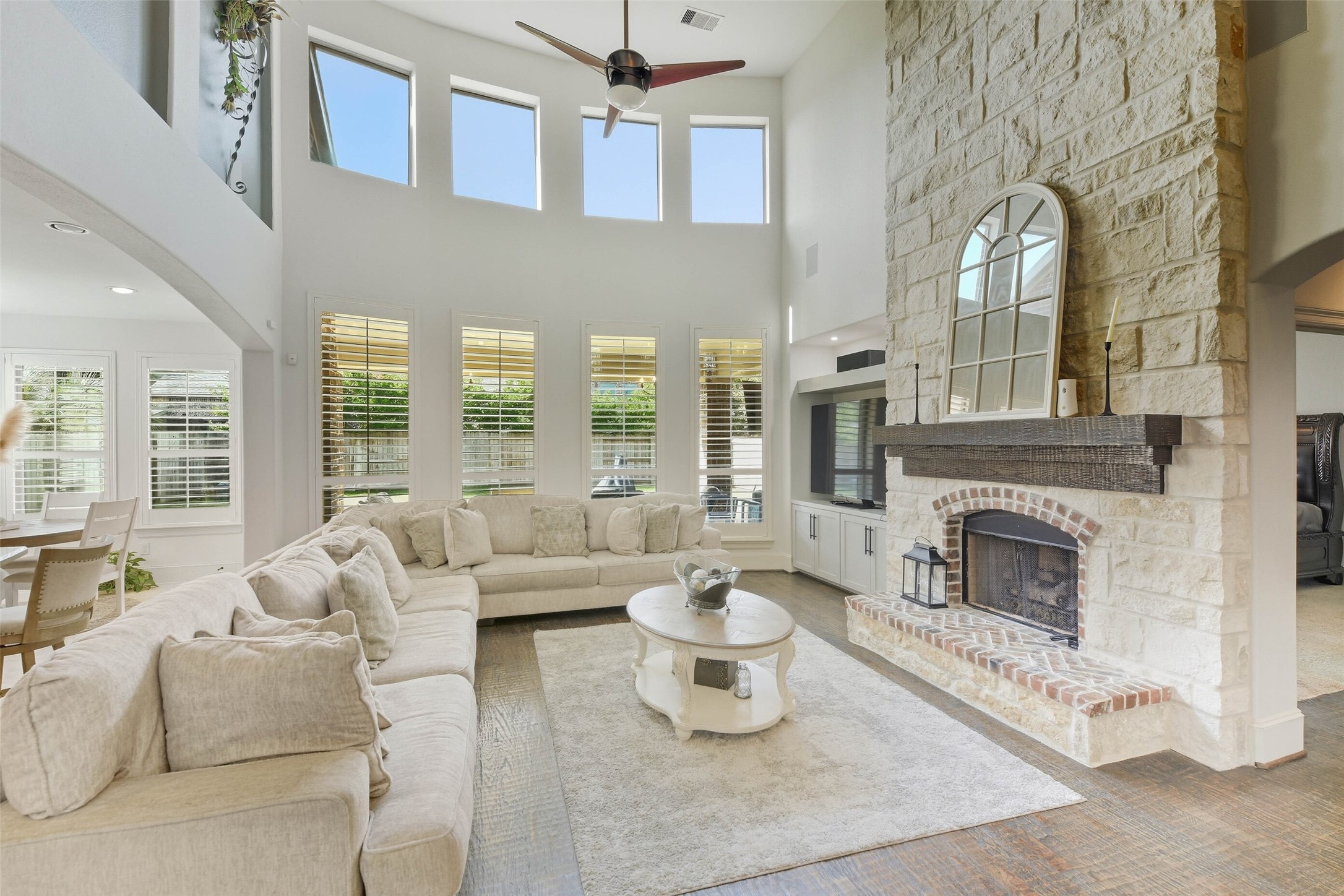 17611 Fossil Ridge Lane Humble, TX 77346 - Photo 8 of 36 a living room with furniture a fireplace and large windows
