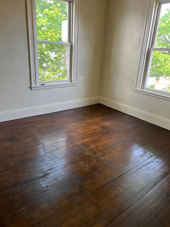 71 Harwood Street, Unit 12 Lynn, MA 01902 - Photo 1 of 5 an empty room with wooden floor and windows