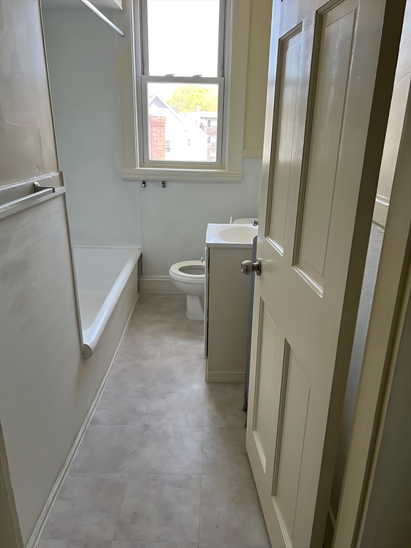 71 Harwood Street, Unit 12 Lynn, MA 01902 - Photo 4 of 5 a view of a bathroom with a sink and a mirror