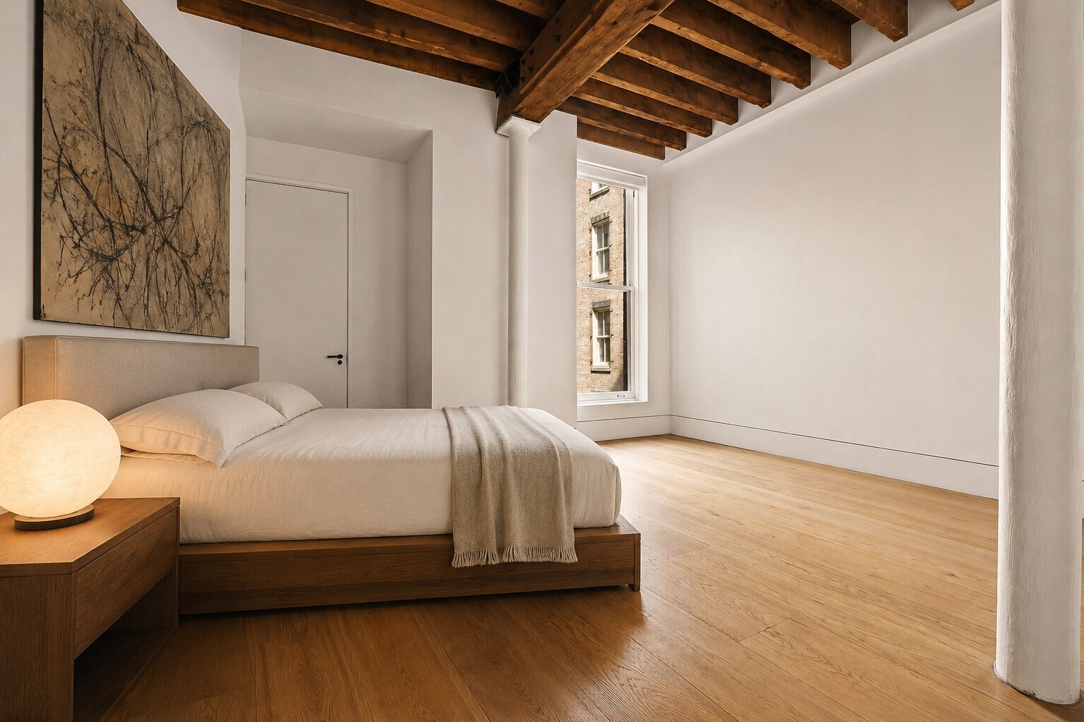 62 Wooster Street, Unit 4 Manhattan, NY 10010 - Photo 10 of 13 a bedroom with a bed couch and a window