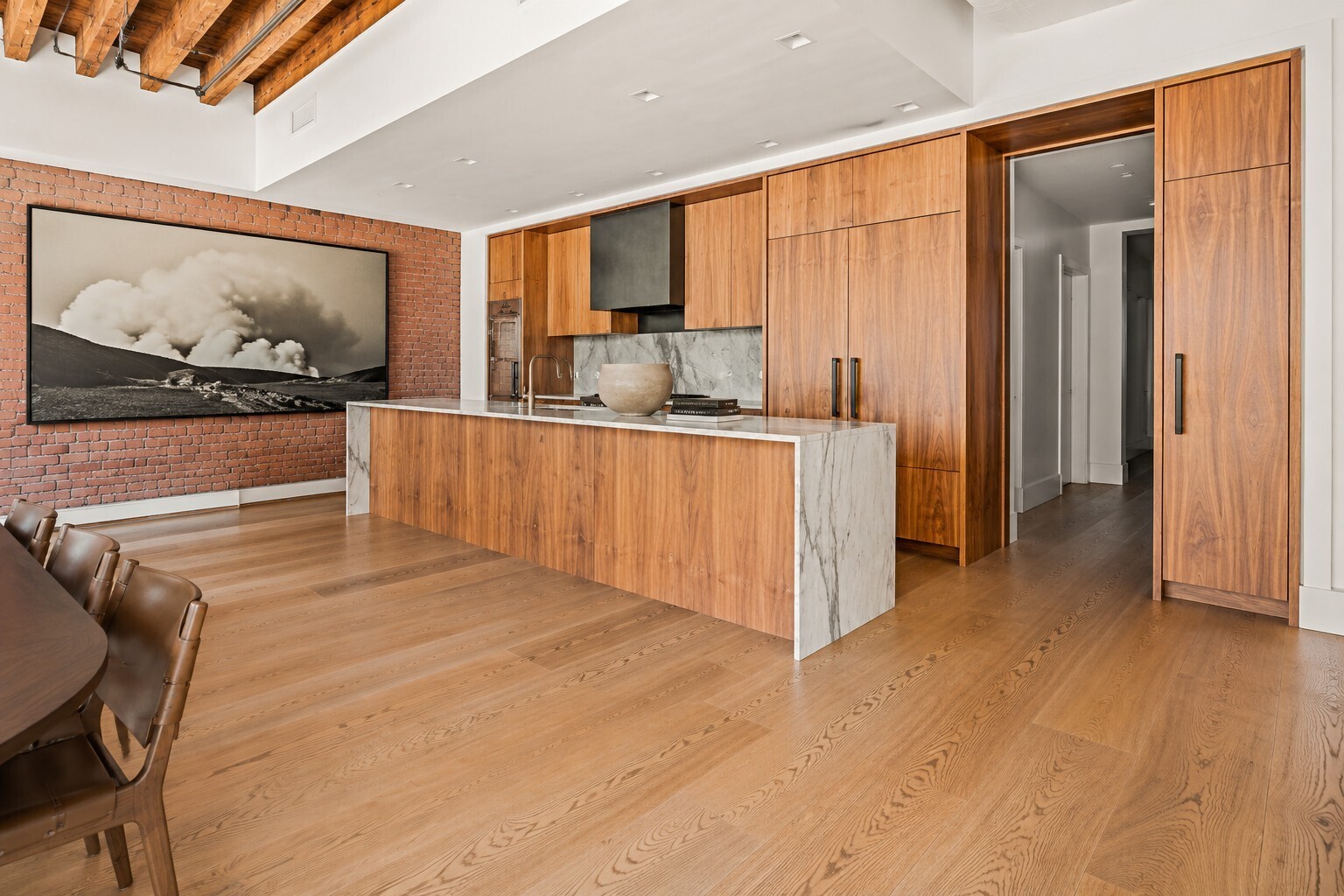 62 Wooster Street, Unit 4 Manhattan, NY 10010 - Photo 4 of 13 a view of a kitchen with kitchen island wooden floor and window
