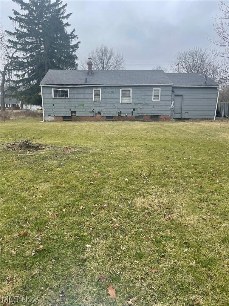 11153 Prospect Road Strongsville, OH 44149 - Photo 12 of 25 Rear view of house featuring a lawn