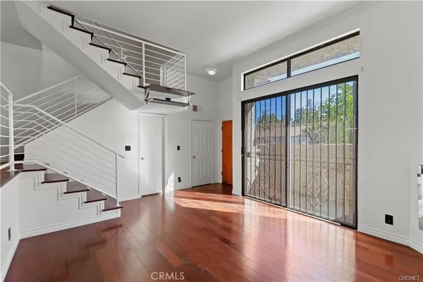 a view of an entryway with wooden floor