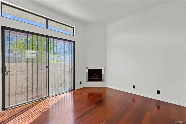a view of a livingroom with wooden floor and a ceiling fan