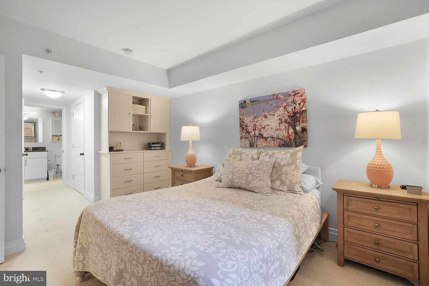 915 E Street Northwest, Unit 403 Washington, DC 20004 - Photo 12 of 30 a bedroom with a bed and lamp