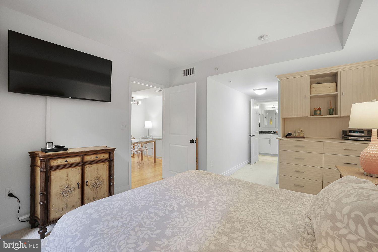 915 E Street Northwest, Unit 403 Washington, DC 20004 - Photo 13 of 30 a bedroom with a bed and a flat screen tv