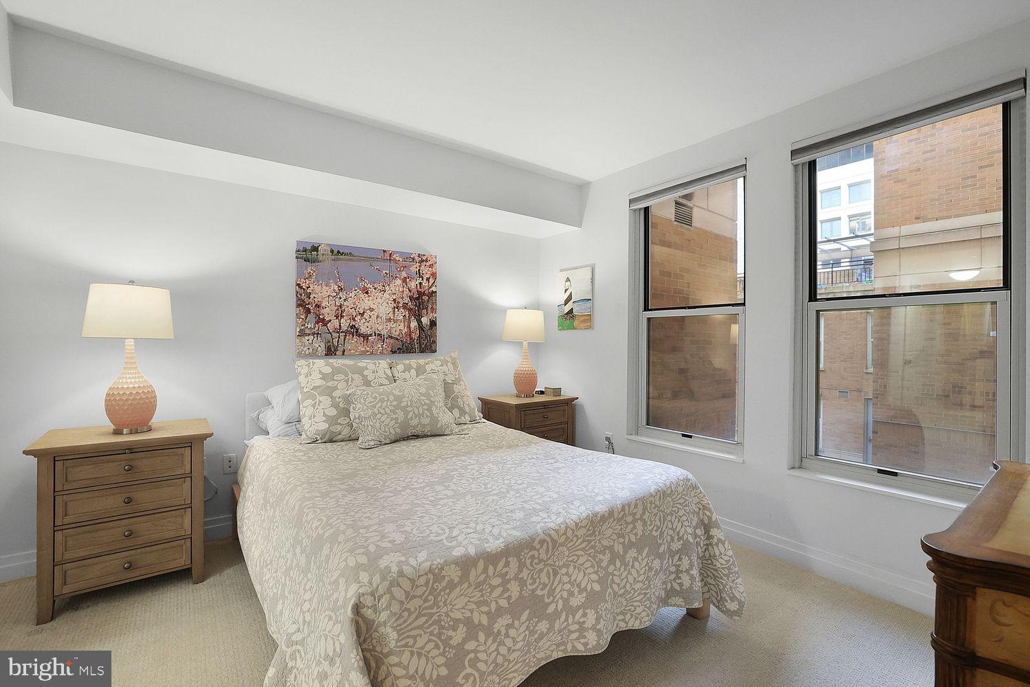 915 E Street Northwest, Unit 403 Washington, DC 20004 - Photo 14 of 30 a bedroom with a bed and wooden floor