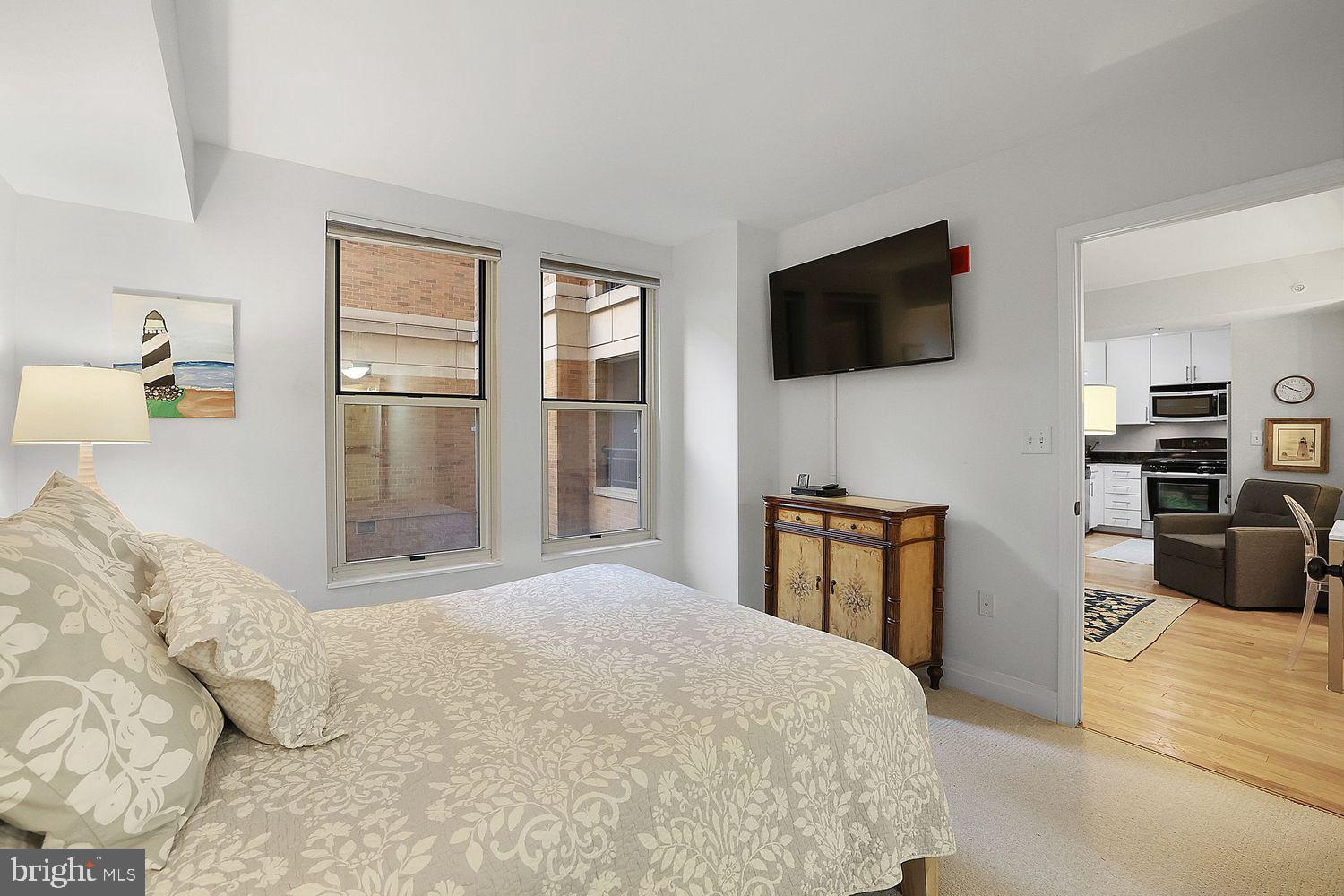 915 E Street Northwest, Unit 403 Washington, DC 20004 - Photo 15 of 30 a bedroom with a bed and a television