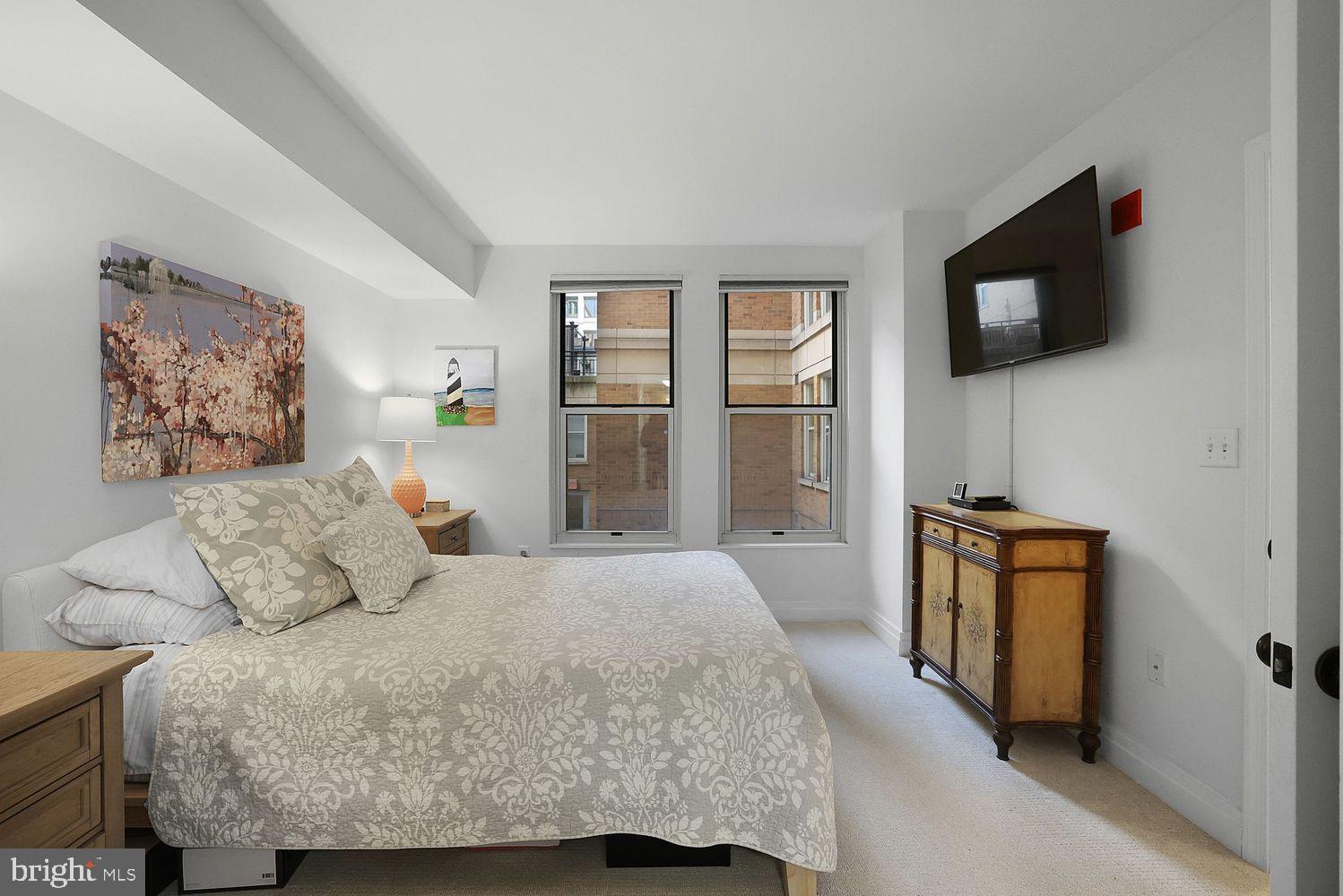 915 E Street Northwest, Unit 403 Washington, DC 20004 - Photo 16 of 30 a bedroom with a bed and a television