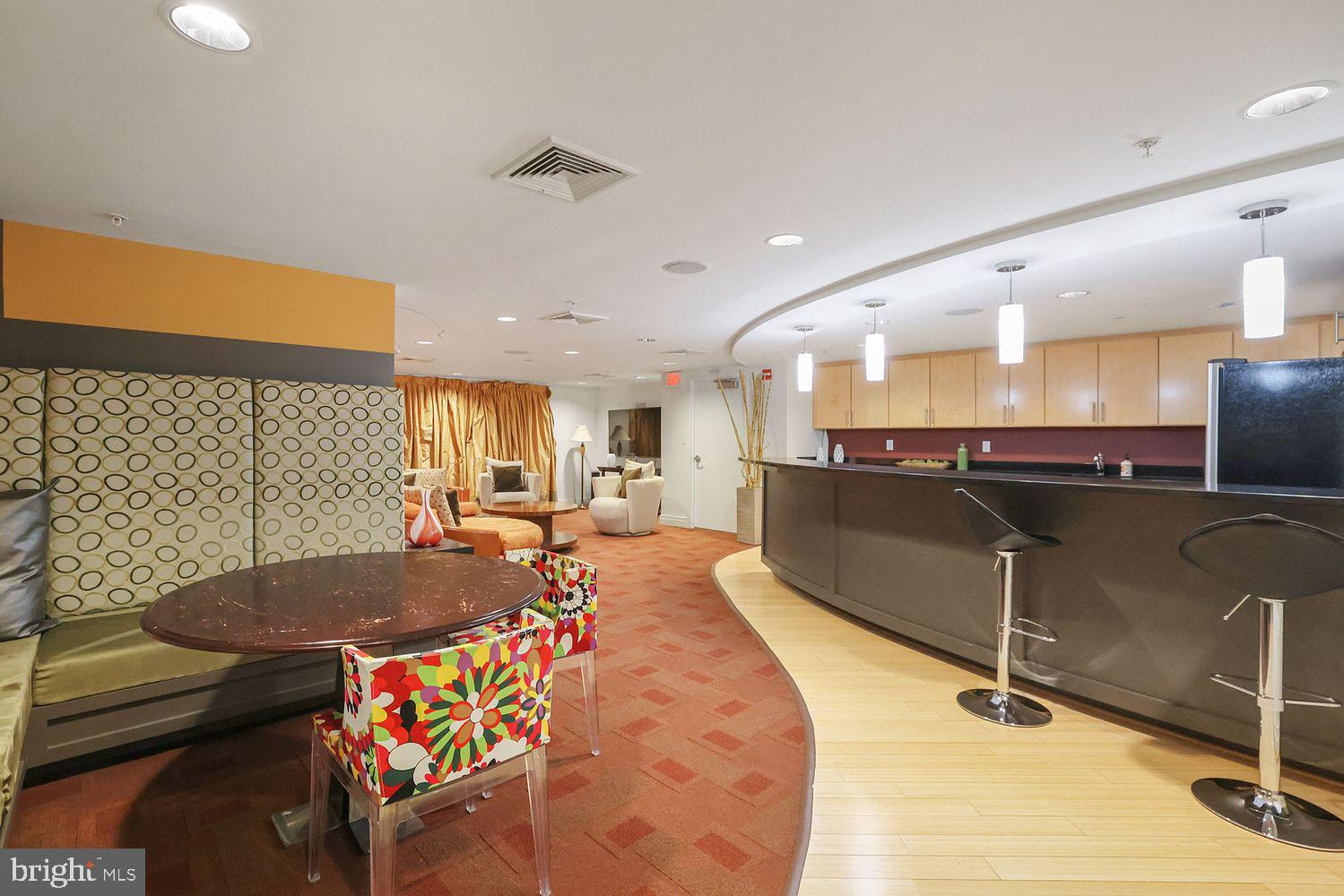 915 E Street Northwest, Unit 403 Washington, DC 20004 - Photo 26 of 30 a living room with a table and chairs