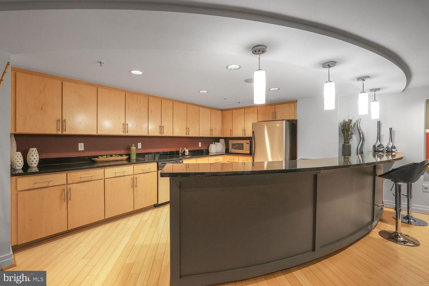 915 E Street Northwest, Unit 403 Washington, DC 20004 - Photo 27 of 30 a kitchen with stainless steel appliances granite countertop a sink a stove and a refrigerator