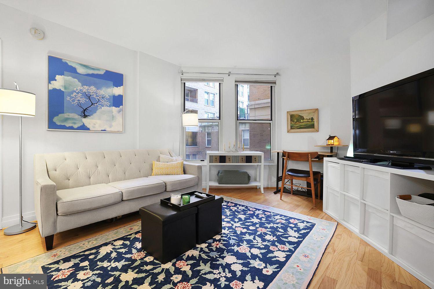 915 E Street Northwest, Unit 403 Washington, DC 20004 - Photo 5 of 30 a living room with furniture and a flat screen tv