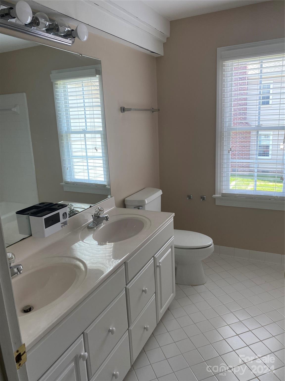 1623 Caille Court Fort Mill, SC 29708 - Photo 35 of 41 a bathroom with a double vanity sink toilet and a mirror