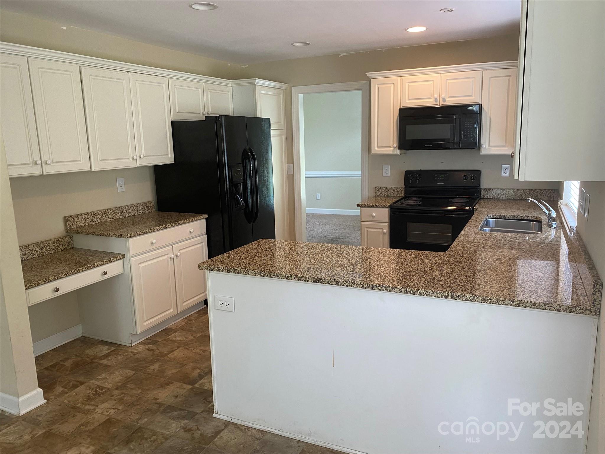 1623 Caille Court Fort Mill, SC 29708 - Photo 5 of 41 a kitchen with granite countertop a refrigerator and a stove top oven
