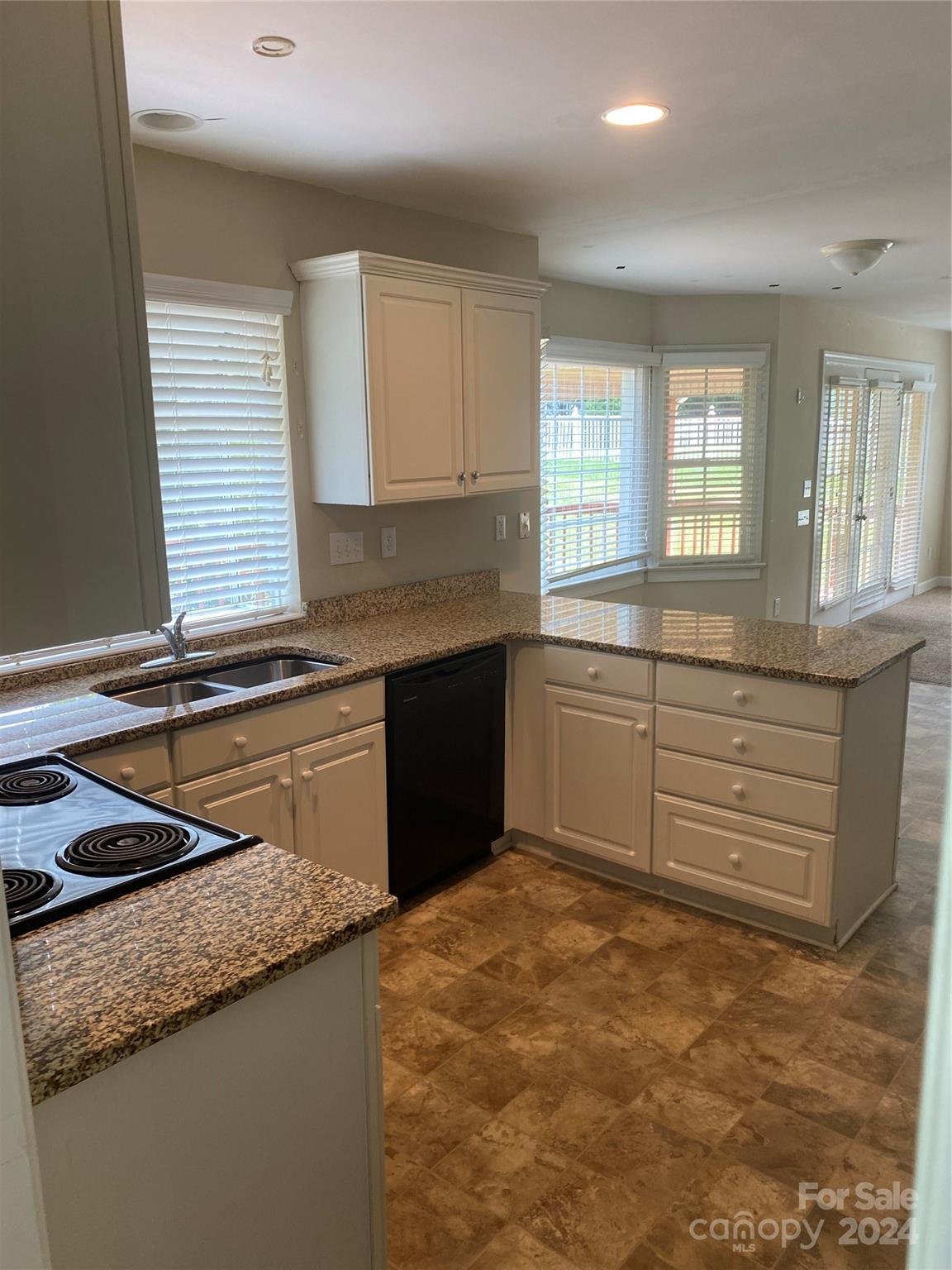 1623 Caille Court Fort Mill, SC 29708 - Photo 10 of 41 a kitchen with granite countertop a sink and a stove