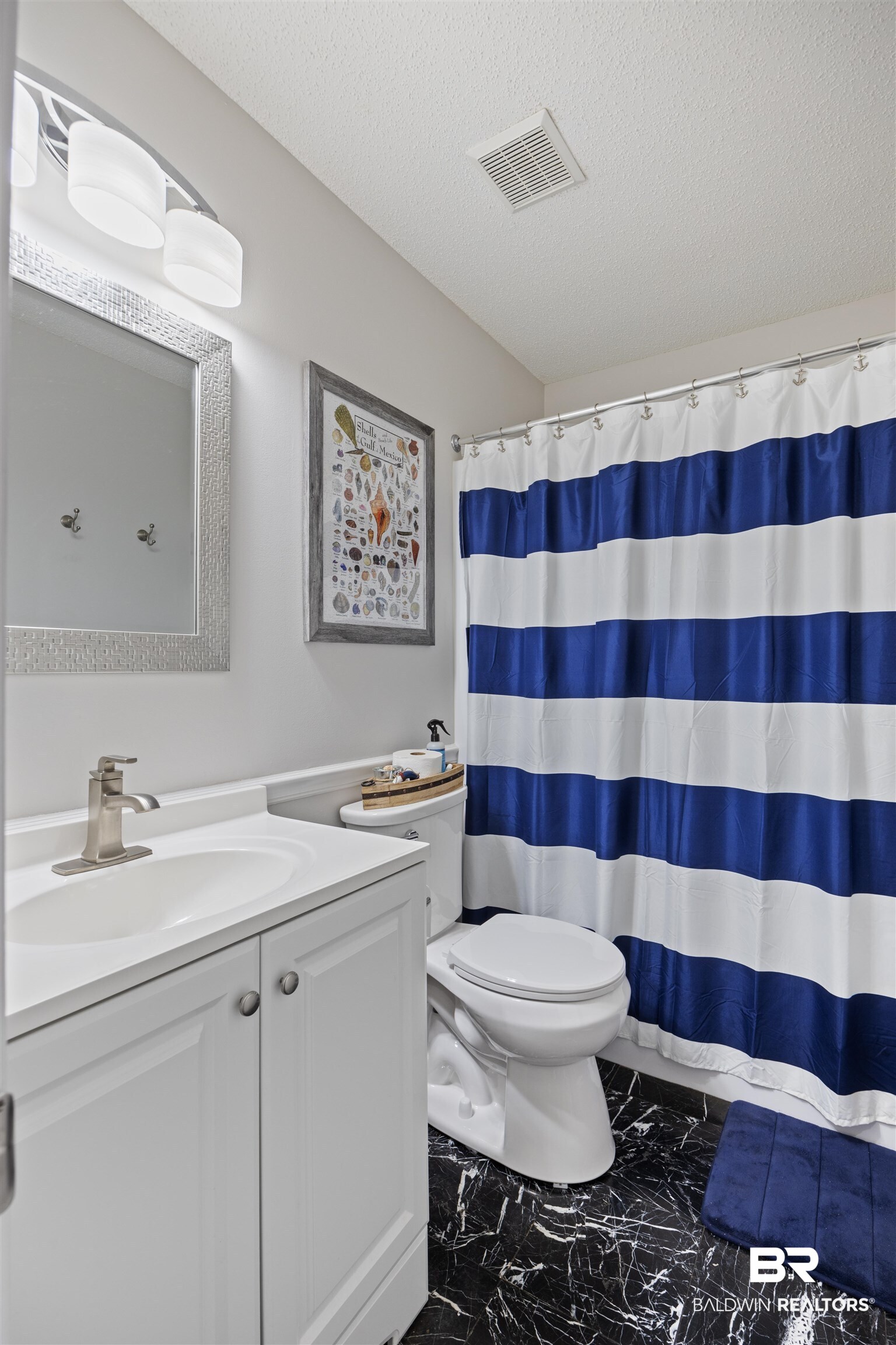 9771 Clarke Ridge Road Foley, AL 36535 - Photo 45 of 72 Full bath featuring a textured ceiling, toilet, marble finish floor, and vanity.