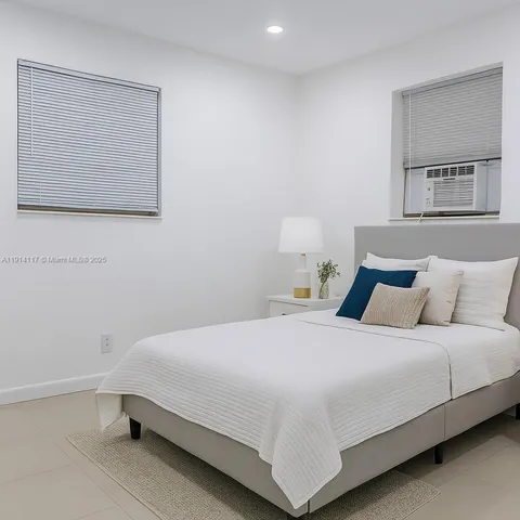 a bedroom with a bed and wall painting