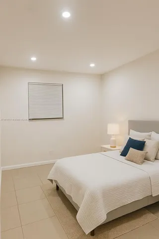 a bedroom with a bed and a night stand