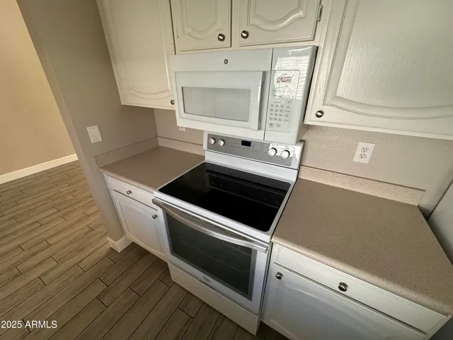 a close view of stove top oven and cabinets
