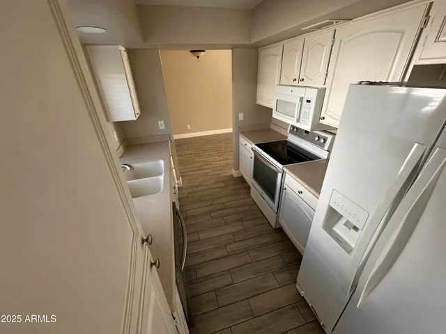 a kitchen with sink a refrigerator and washer