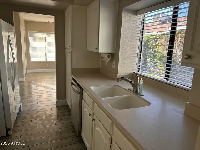a bathroom with a sink a toilet and a window