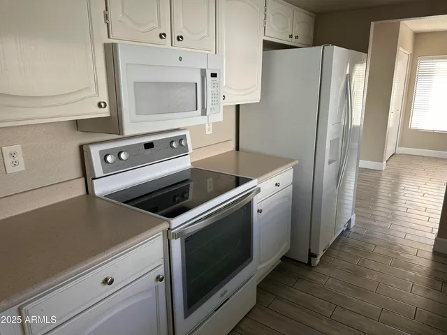 a kitchen with a stove microwave and refrigerator