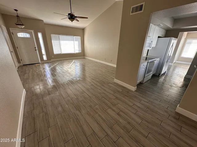 wooden floor in an empty room with a window