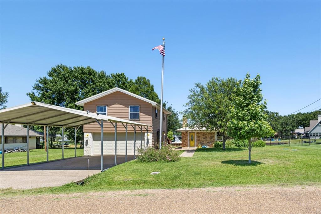 227 Scenic Road Trinidad, TX 75163 - Photo 2 of 40 a front view of a house with a yard
