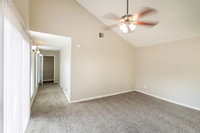 a view of a chandelier fan and a window
