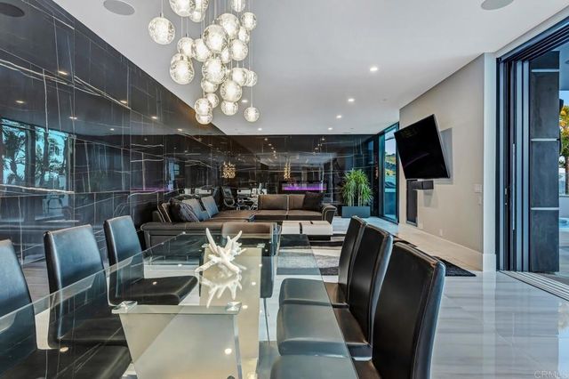 a view of a backyard with table and chairs and potted plants