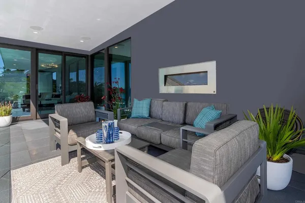 a bedroom with a bed a flat screen tv and a large window